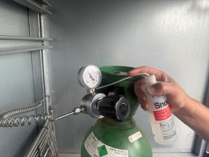 Technician performing a gas leak check